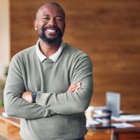 Business, confidence and portrait black man with smile in office, startup ceo or owner at hr company. Happiness, project management and happy, confident professional businessman at recruitment agency